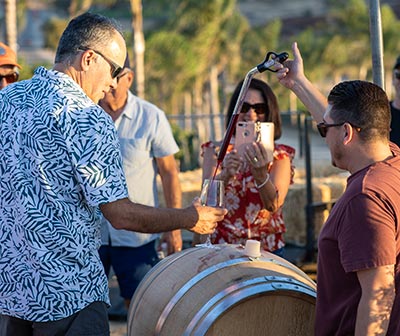 Image of wine poured into a glass from the barrel.